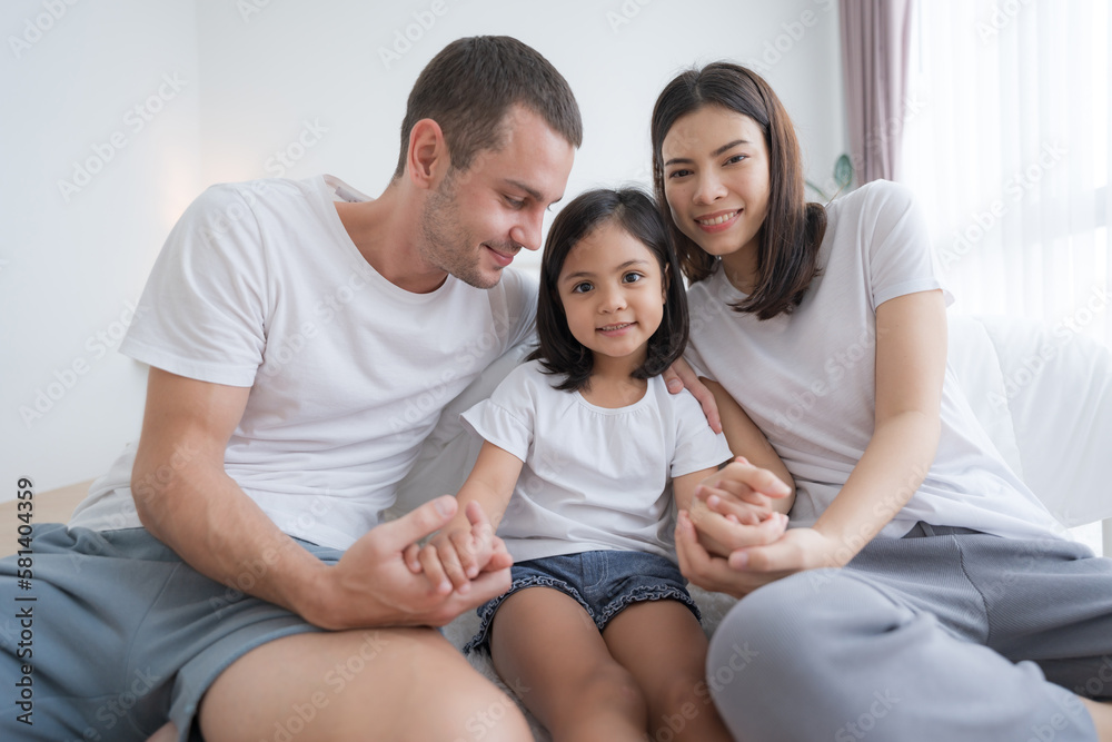 Happy family sitting on the floor with their baby. Happy family sitting on the floor with their baby.