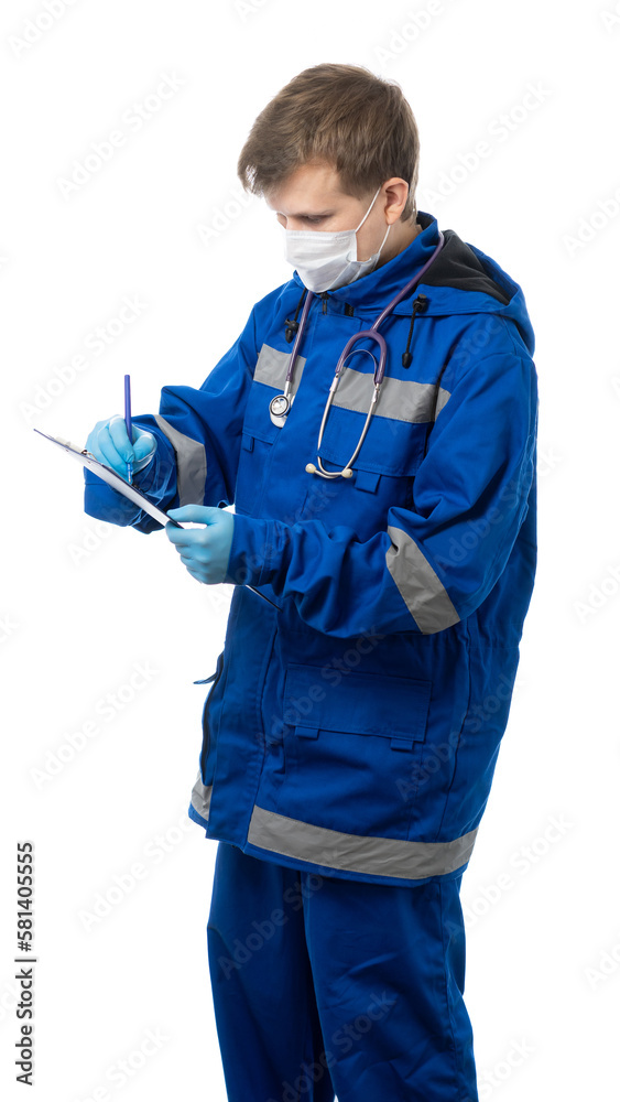Paramedic, a doctor in a medical mask holds a tablet with a sheet of paper, a document and writes something into it. A man, a medical professional is looking at a document. isolated Paramedic, a doctor in a medical mask holds a tablet with a sheet of paper, a document and writes something into it. A man, a medical professional is looking at a document. isolated