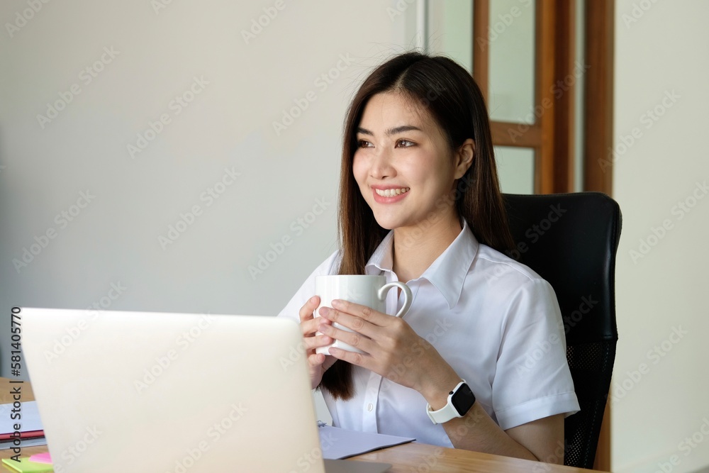 Beautiful young woman working on laptop computer while sitting in cafe. Freelancer business woman thinking about new ideas during work on laptop computer, drink coffee, enjoy of coffee smell. Beautiful young woman working on laptop computer while sitting in cafe. Freelancer business woman thinking about new ideas during work on laptop computer, drink coffee, enjoy of coffee smell.