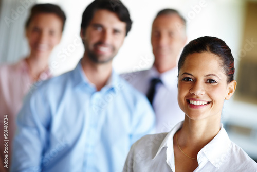 She will lead her team to greatness. A confident businesswoman standing infront of her colleagues.