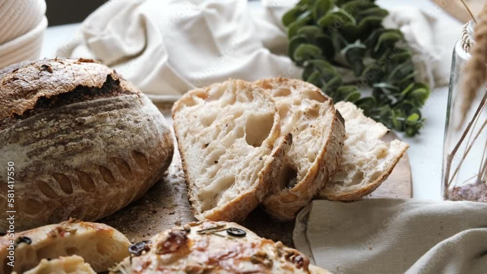Artisan Batard Sourdough healthy Bread with leaf scoring. Open crumb high hydration Sourdough bread set on white table. Artisan Batard Sourdough healthy Bread with leaf scoring. Open crumb high hydration Sourdough bread set on white table.