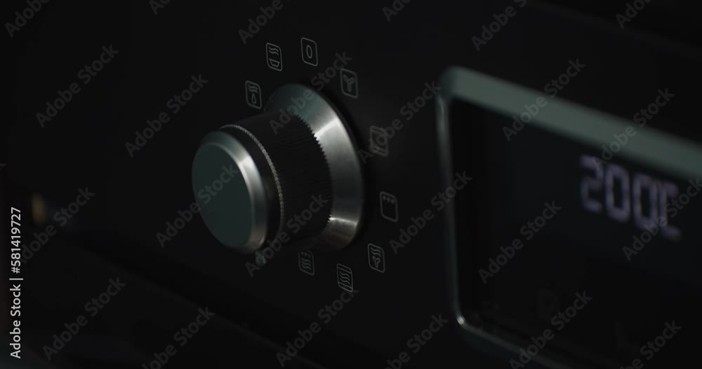 Close up static shot of hand adjusting electronic equipment dial, dark room Close up static shot of hand adjusting electronic equipment dial, dark room