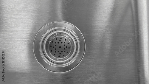 Close-up view of stainless steel sink with drain. 