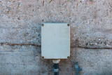 Exterior plastic electrical box mounted on concrete wall