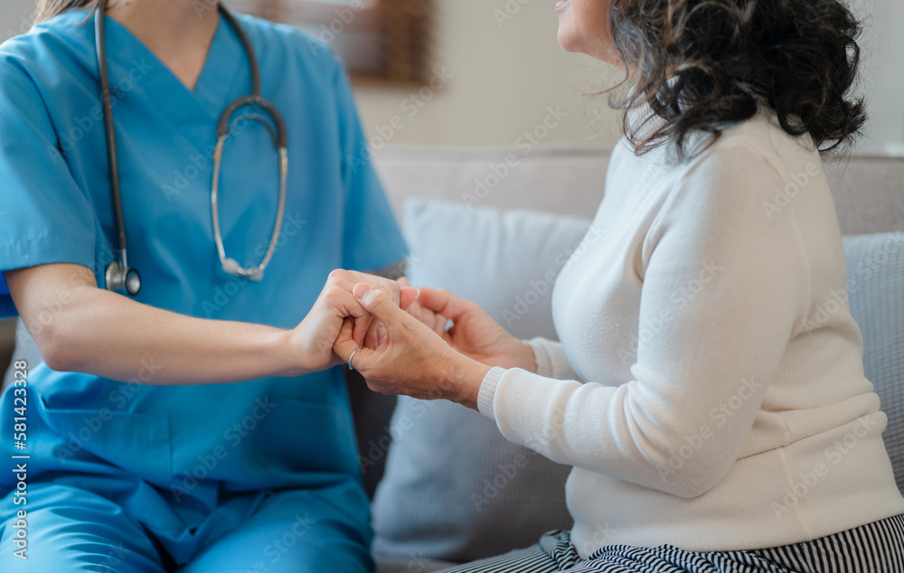 Doctor's hand reassuring elderly patient.