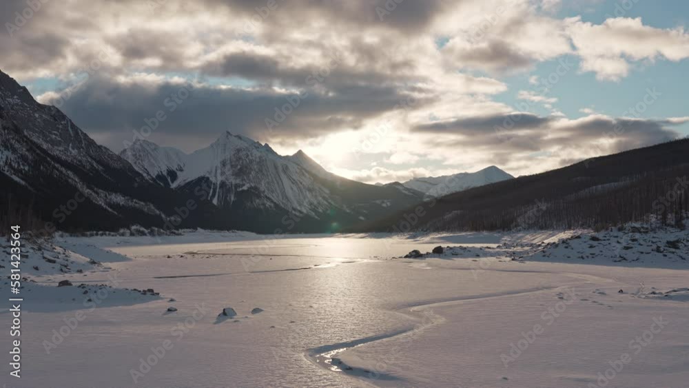 Sunrise over Medicine Lake with rocky mountains and frozen lake in Jasper national park Sunrise over Medicine Lake with rocky mountains and frozen lake in Jasper national park