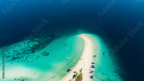 Aerial drone of beautiful Sibuan island with a beach and a coral atoll. Tun Sakaran Marine Park. Borneo, Sabah, Malaysia.