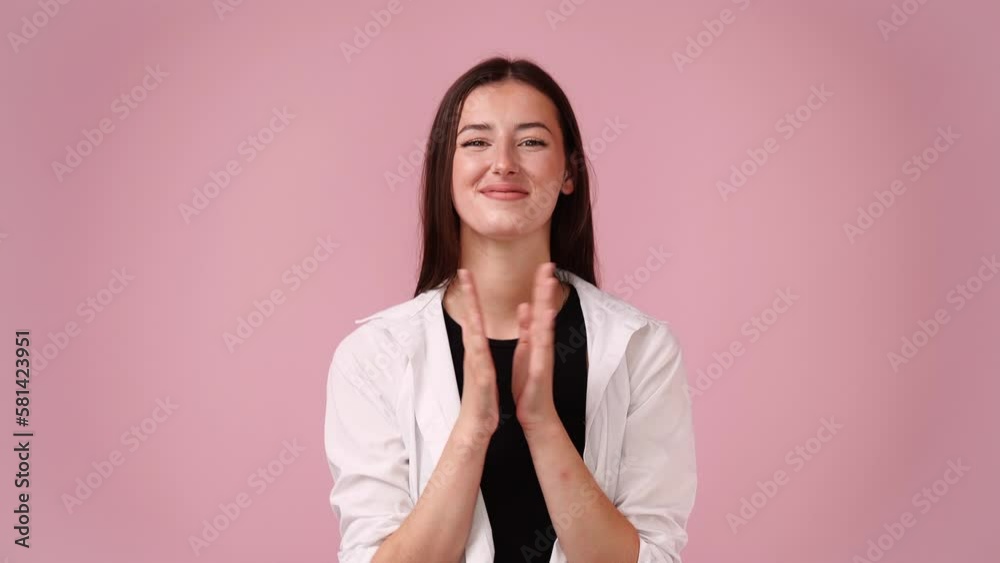4k video of excited girl clapping in hands on pink background. 4k video of excited girl clapping in hands on pink background.