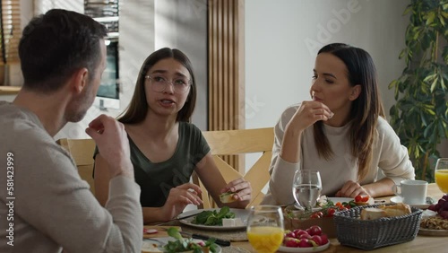 Caucasian family having a vivid conversation during the breakfast. Shot with RED helium camera in 8K. 
