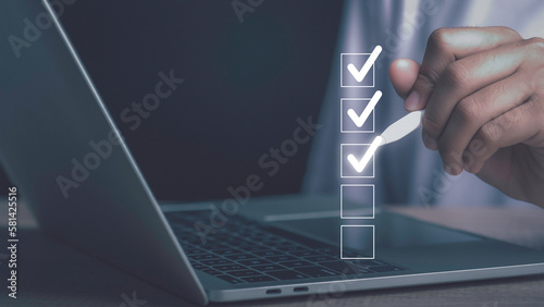 Digital work checklist or electronic smart daily checklist concept. Check mark on virtual screen display for personal working in office Document Management System and process automation.
