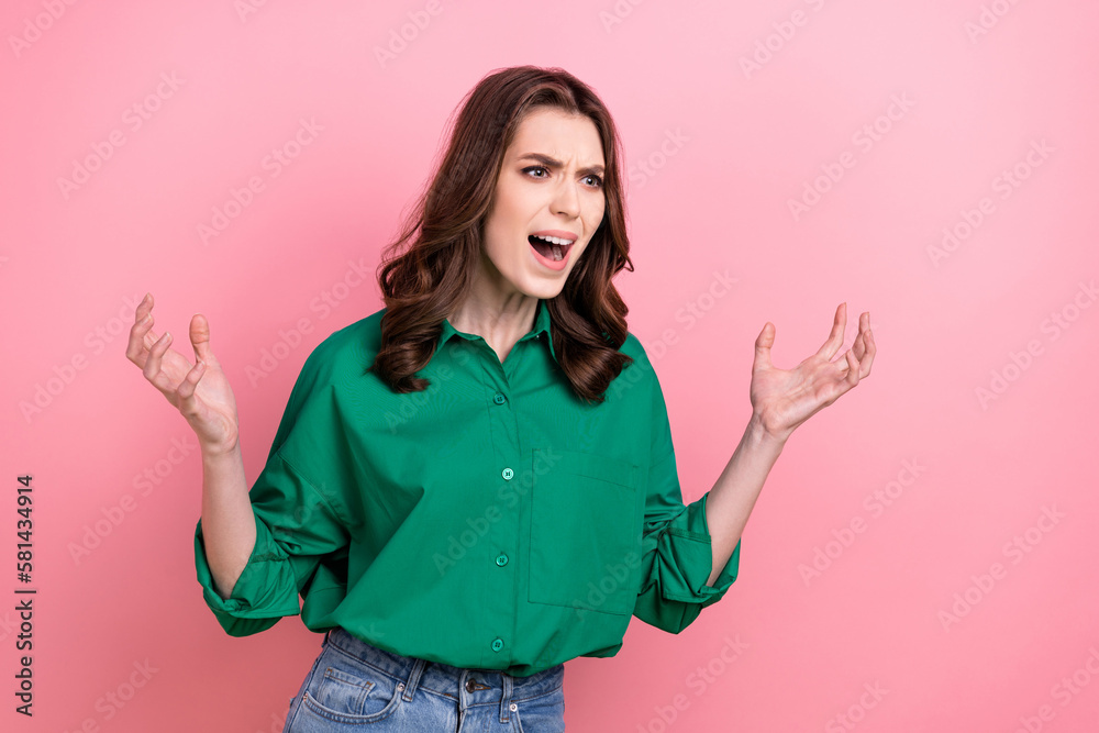 Photo of angry furious woman wear green shirt shouting rising arms hands empty space isolated pink color background - obrazy, fototapety, plakaty 