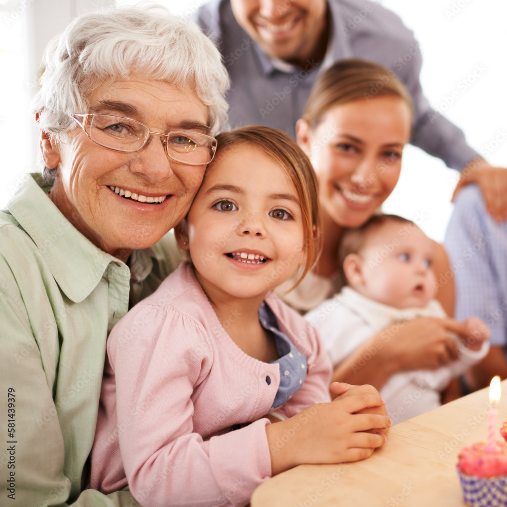 Theyre a festive family. Grandparents sitting with their granddaughter on her birthday. Theyre a festive family. Grandparents sitting with their granddaughter on her birthday.