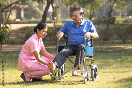 Photography Senior man making physiotherapy session with young nurse.