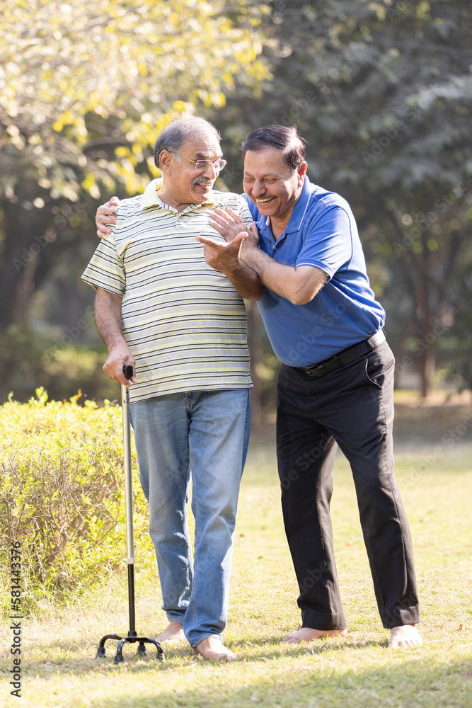 Two happy senior male friends spending leisure time at park Two happy senior male friends spending leisure time at park