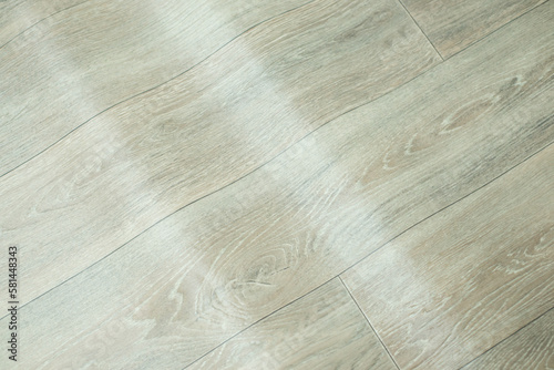 Waves on linoleum floor. Freshly unrolled linoleum, uneven surface on floor, low quality of linoleum floor concept