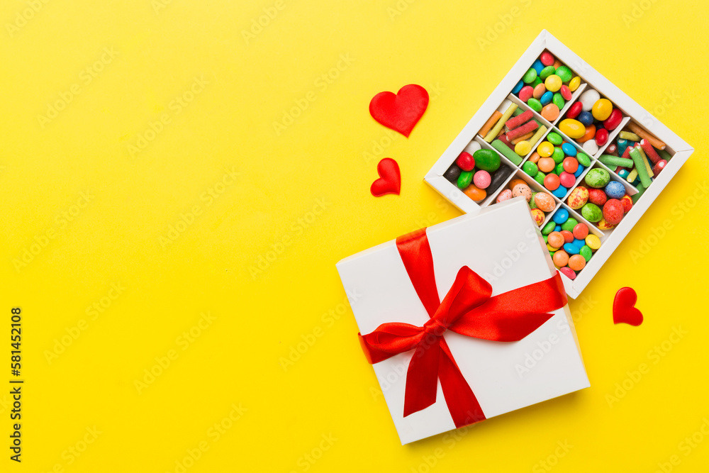 Valentine day composition: sweet candy, with gift boxes with bow and red felt hearts, photo template, background. Top View with copy space Valentine day composition: sweet candy, with gift boxes with bow and red felt hearts, photo template, background. Top View with copy space