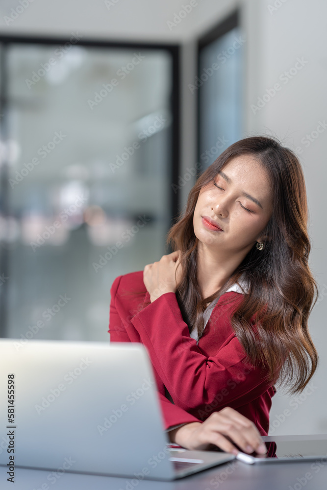 Asian businesswoman sitting in office stressed and fatigued from overwork on financial matters on office desk. Asian businesswoman sitting in office stressed and fatigued from overwork on financial matters on office desk.