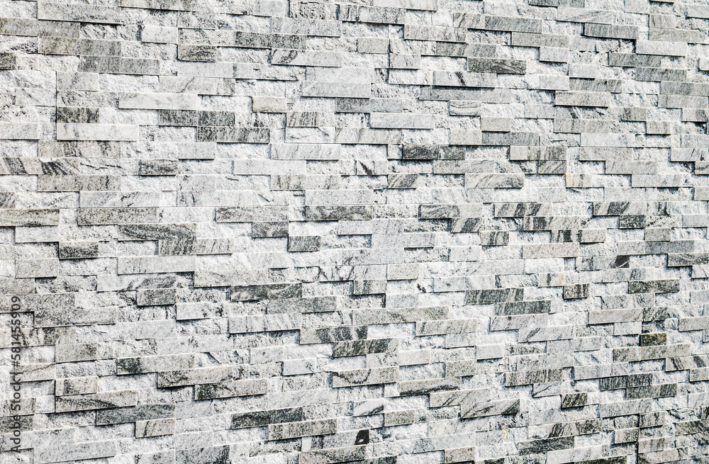 Fototapeta premium abstract stone wall made of gray marble tiles, selective focus, copy space. Wallpaper