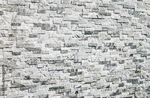 abstract stone wall made of gray marble tiles  selective focus  copy space. Wallpaper