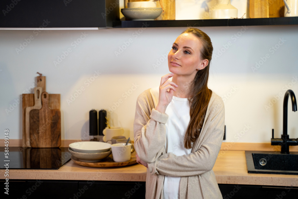 Thoughtful young woman in the kitchen at home. Thoughtful young woman in the kitchen at home.