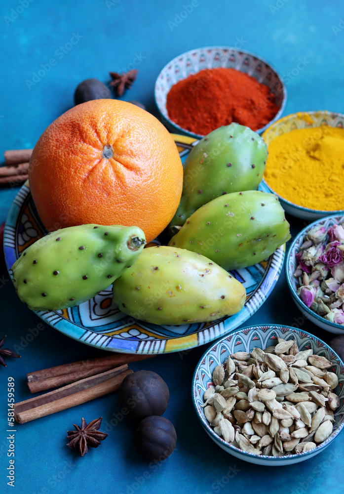 Top view photo of various spices on a blue table. Vivid background with copy space.  Food flavoring concept. 