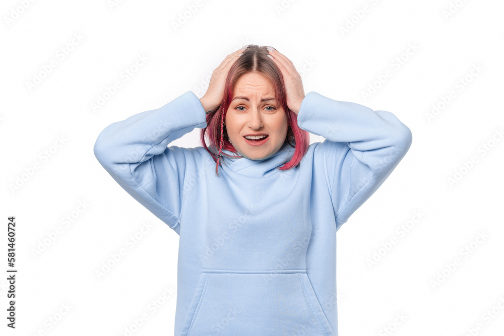 nervous woman with pink hair wearing blue hoodie standing over white background surprised with hand on head for mistake, remember error. Forgot, bad memory concept nervous woman with pink hair wearing blue hoodie standing over white background surprised with hand on head for mistake, remember error. Forgot, bad memory concept