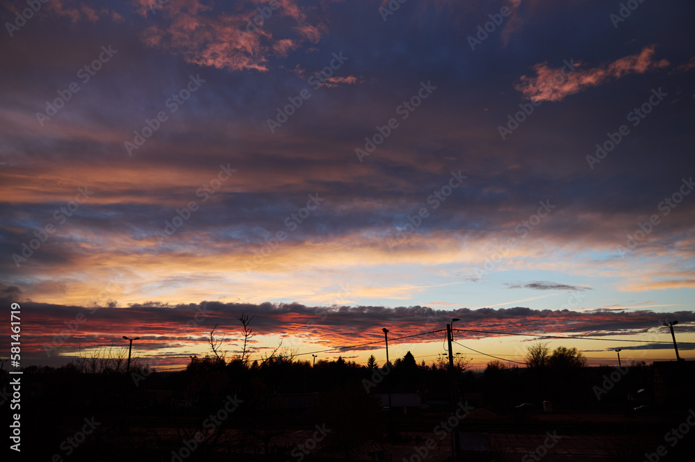 Colorful evening sky on the background of contours Colorful evening sky on the background of contours