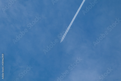 Plane in the sky.Flight from the plane.Airplane high in the sky.Flying in the sky.Blue heaven.Travel agency.White trail in the sky from the plane.Traveling by plane.Blue beautiful heaven.Flying high.