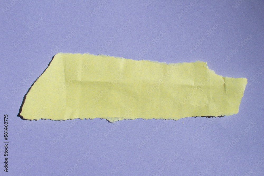Crumpled yellow paper piece on a purple background. Torn paper background. Crumpled yellow paper piece on a purple background. Torn paper background.
