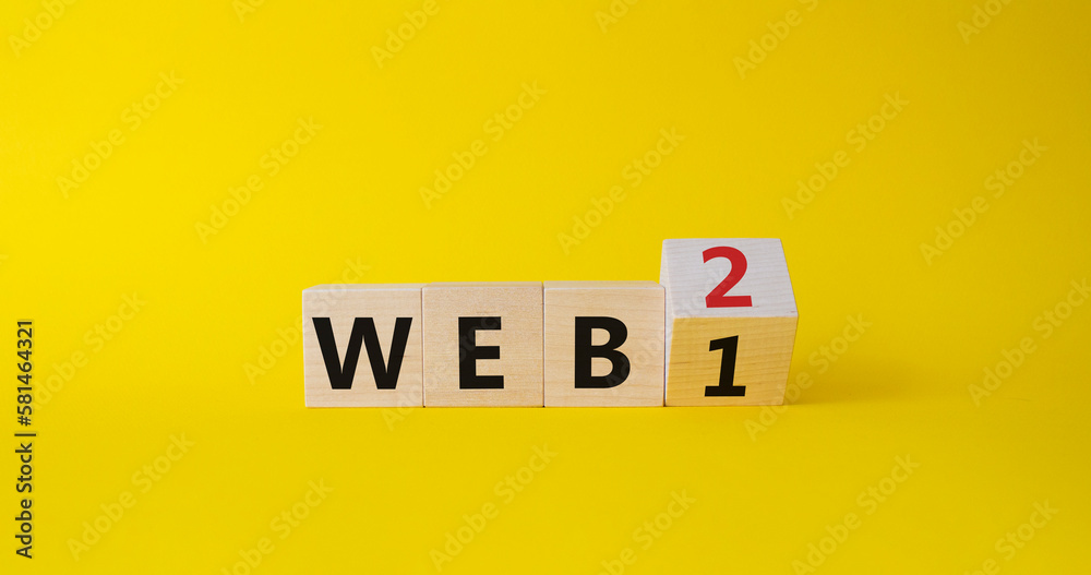 WEB 2 or 1 symbol. Turned wooden cubes with words WEB 1 and WEB 2. Beautiful yellow background. Business and WEB concept. Copy space WEB 2 or 1 symbol. Turned wooden cubes with words WEB 1 and WEB 2. Beautiful yellow background. Business and WEB concept. Copy space