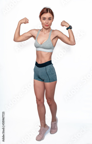 Slender female body pumped muscles. Sporty woman in shorts and top. Bodybuilding. Healthy Lifestyle.