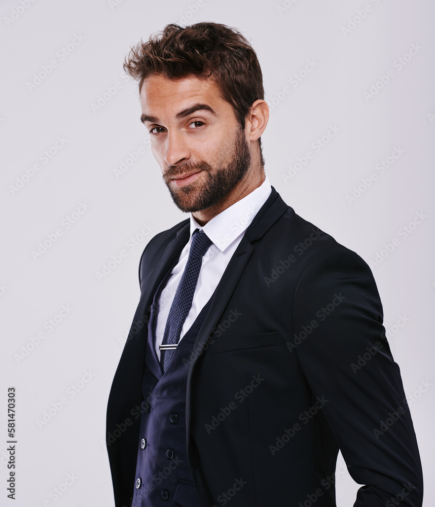 Handsome and successful. Studio shot of a well-dressed man against a gray background. Handsome and successful. Studio shot of a well-dressed man against a gray background.