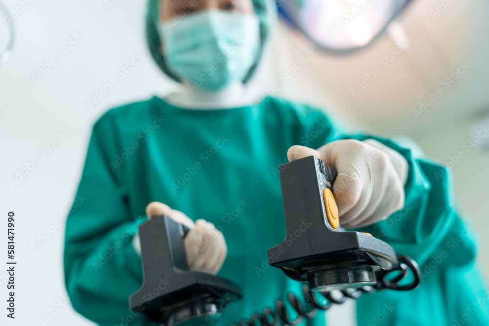 Medical urgency in the ambulance. Emergency doctor using defibrillator