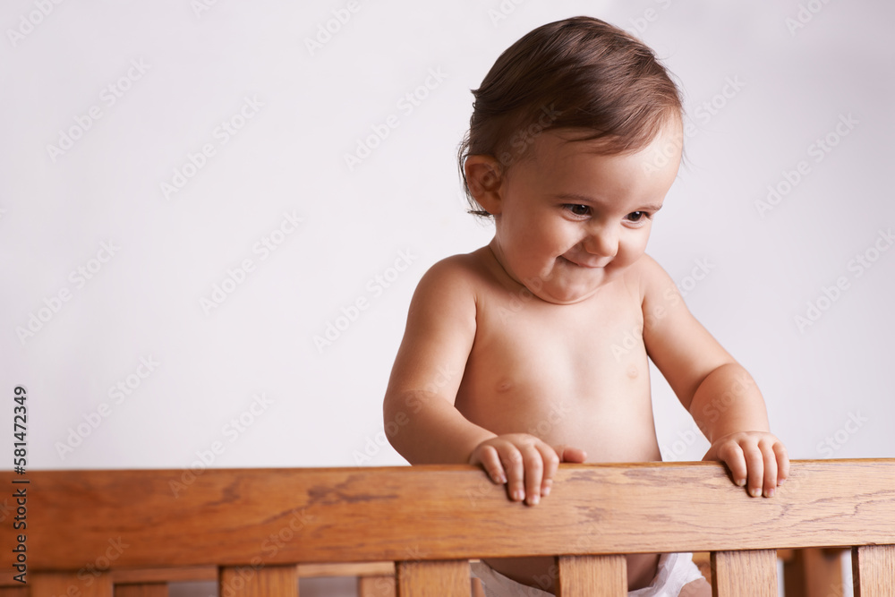 She always wakes up with a smile. A cute little baby girl in her crib at home. She always wakes up with a smile. A cute little baby girl in her crib at home.