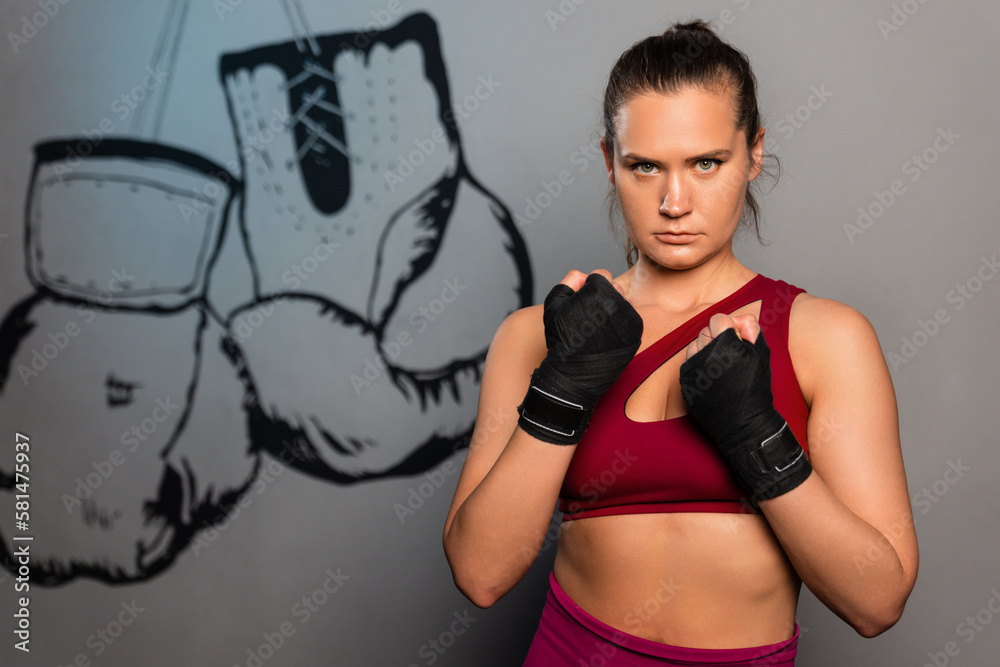 Obraz premium Portrait of a sporty woman who is preparing for boxing training