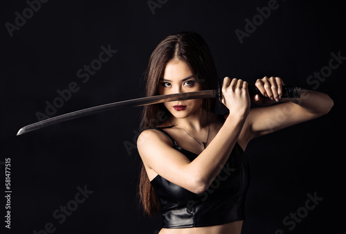 Beautiful asian woman with Japanese sword. Cropped image.