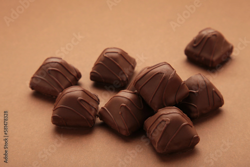 Chocolate candies on brown background. Top view