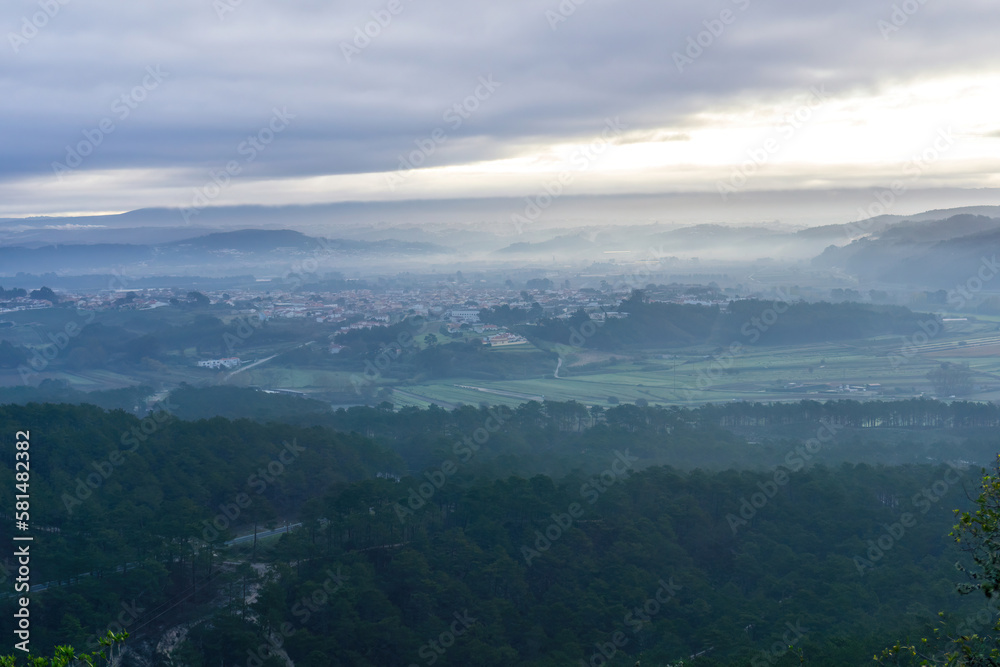 Landscape with forests in fog on the beach and village Landscape with forests in fog on the beach and village