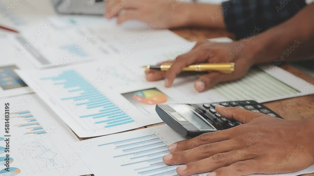 Financial analysts analyze business financial reports on a digital tablet planning investment project during a discussion at a meeting of corporate showing the results of their successful teamwork.