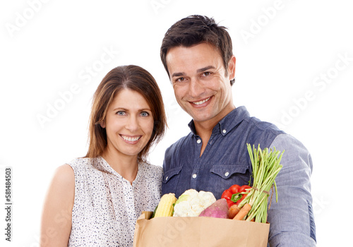 Fresh is best. Studio portrait of a couple with groceries isolated on white.