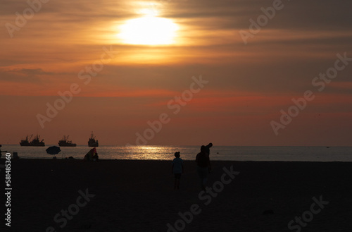 Sunset at Chinchorro beach, with the red sun slowly going down © cristian