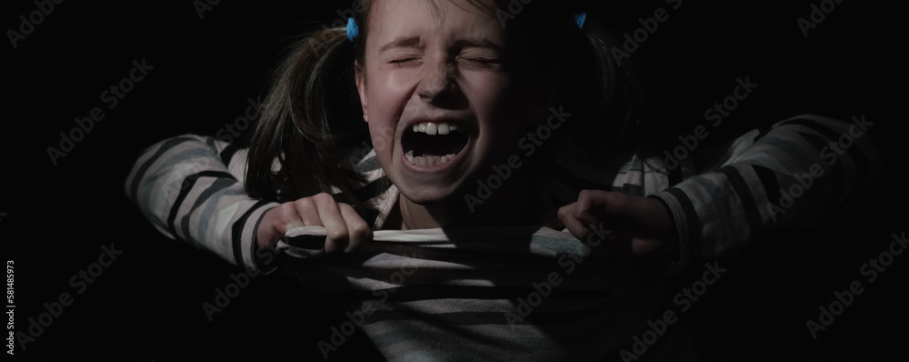 Fototapeta premium Conceptual image: loss childhood, pain, mental health, stress, psychology, depression, panic attacks and anxiety in children. Nervous child girl screams for help. Horizontal image.