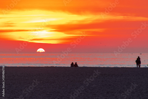 Sunset at Chinchorro beach, with the red sun slowly going down © cristian