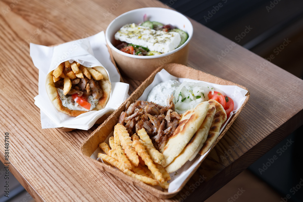 Greek fast food served for take away. Traditional pita souvlaki, gyros ...