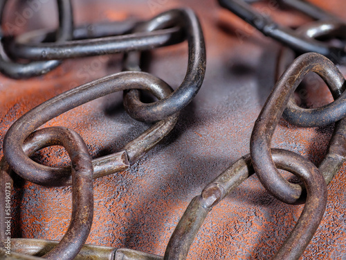 Detail texture of old rusty link chain on a grunge background