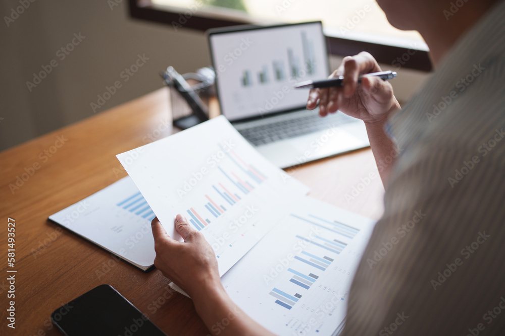 Woman calculating monthly expenses, taxes and interest calculate at home..