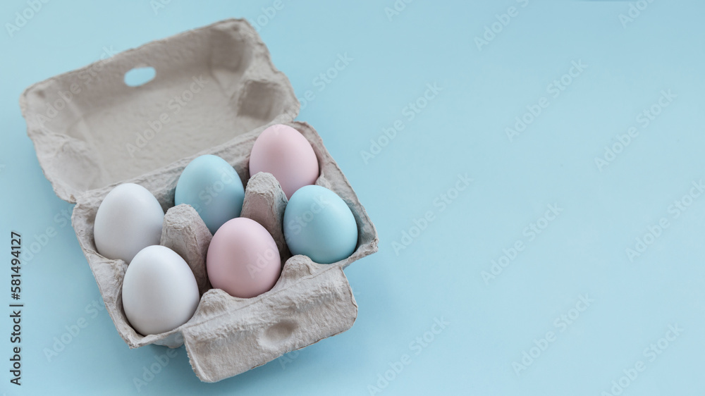 Natural Easter eggs in an eco paper box on a blue background