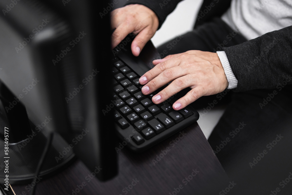 seen from above, man with Hands on desktop or table computer keyboard, corporate concept. seen from above, man with Hands on desktop or table computer keyboard, corporate concept.