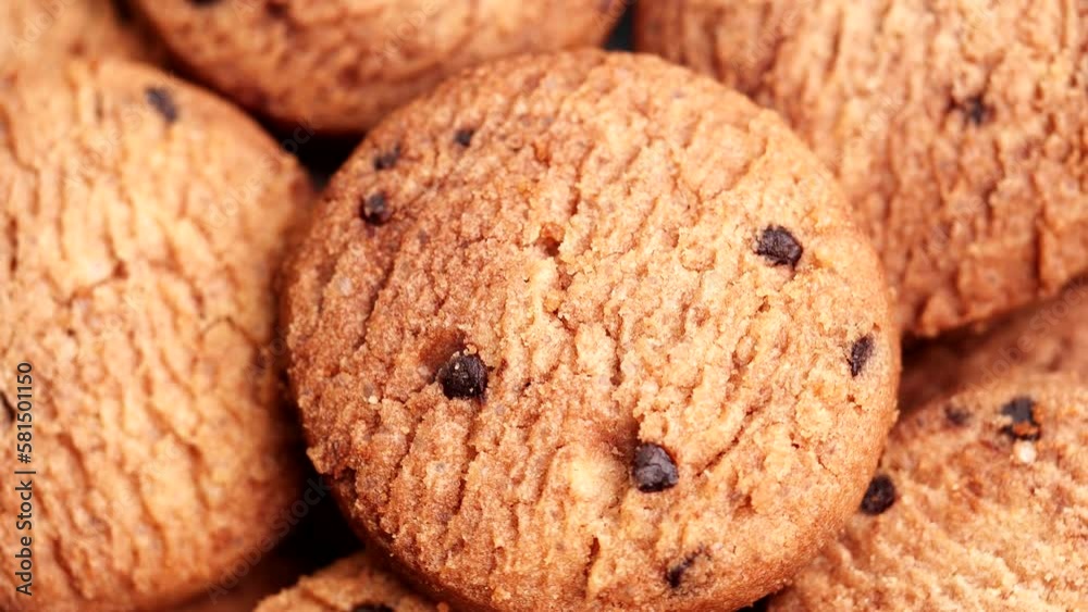 Close-up Homemade Cookies top view, Chocolate chip cookies turning, rotating on table, slow motion. Concept of Dessert, Snack, Biscuit, Chocolate Cookies, Bakery, Food, Unhealthy Food Close-up Homemade Cookies top view, Chocolate chip cookies turning, rotating on table, slow motion. Concept of Dessert, Snack, Biscuit, Chocolate Cookies, Bakery, Food, Unhealthy Food