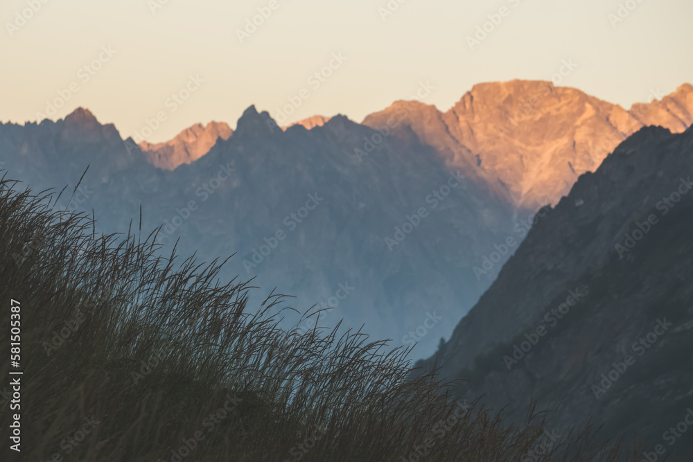 Panorama of a mountain rocky range in the evening at sunset, a minimalistic mountain landscape